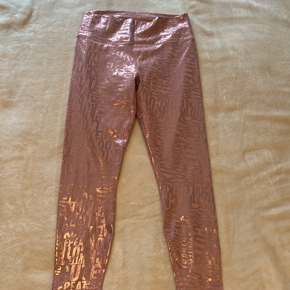 Fabletics Powerhold leggings. Pink with metallic wording throughout. Size medium - Picture 1 of 3